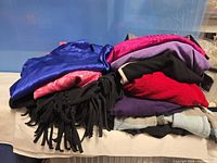 Stack of assorted women’s garments showing colours and fabrics
