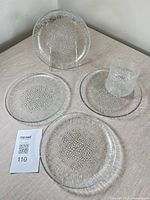 Four plates and one tumbler arranged, showing overall condition