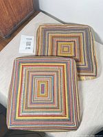 Two square multicolour needlepoint chair cushions