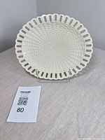 Front of creamware plate showing pierced rim and basketweave design