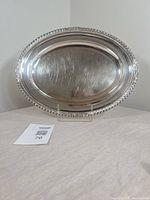 Front view of oval silver-plated tray on stand