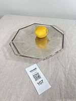 Top view of octagonal silver-plated handled bowl with lemon for scale