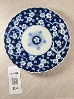 Top view showing blue floral design and scalloped rim