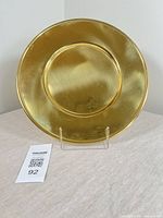 Front view of brass charger showing overall form and finish