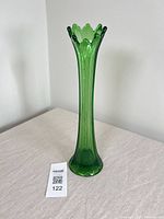 Full view of uranium glass swung vase standing upright