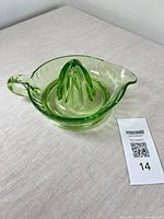 Top view of green uranium glass juicer showing handle, spout, reamer cone