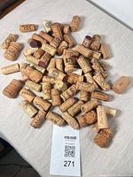 Pile of assorted used corks with MaxSold lot tag visible