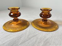 Pair of amber glass candlesticks side by side