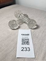 Pair of cut crystal knife rests displayed on fabric surface