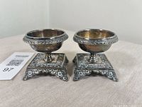 Pair of ornate silver plate salt cellars front angle