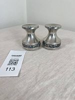 Pair of small pewter candle holders with decorative band