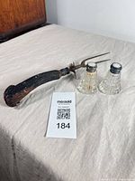 Overall view: antler-handled carving fork alongside two cut glass shakers