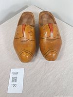 Top view of both wooden clogs showing painted motifs