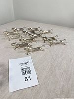 Group view of all 12 silver-plated horse knife rests