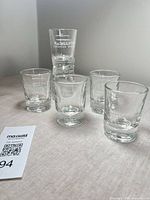 Front view of six MacNaughton branded shot glasses