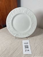 Front view of 9.5 in white ironstone plate standing on display stand