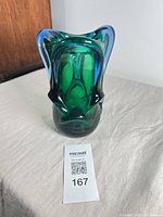 Front view showing green and blue cased glass, overall form, lot tag