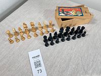 Full set of chess pieces with storage box and auction tag visible