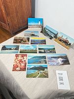 Overview of all postcards spread on table with two propped upright