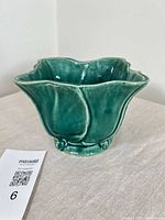 Green glazed ceramic planter with scalloped rim and leaf relief