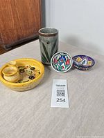 Group shot showing vase, two bowls, olive server