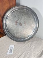 Full view of the round silverplate tray on stand