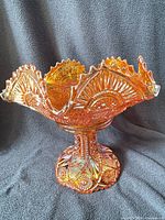 Full view assembled fruit bowl on pedestal showing iridescent marigold glass and scalloped six-point rim
