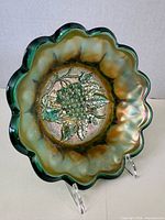 Front interior view of Helios green Heavy Grape carnival glass bowl showing grape pattern and iridescent finish
