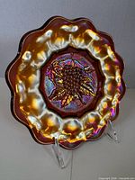 Front view showing marigold iridescence and grape motif