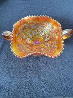 Top view of marigold Northwood bonbon showing Fruits and Flowers interior, crimped rim and handles