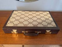 Closed case top showing patterned lid, latches and handle