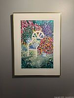 Front view of framed floral chair print on wall