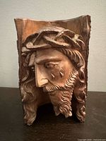 Front view of carved wood Jesus bust showing full facial detail and live-edge sides