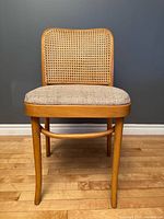 Front view of bentwood chair showing cane back and seat