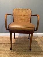 Front view of bentwood armchair showing cane back and seat