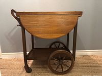 Side view of tea cart showing drop-leaf folded and wheels