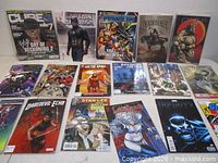 Overview of all 17 comics laid out on table