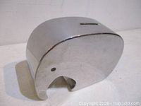 Right side view of polished metal elephant coin bank
