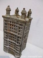 Front and side view of cast iron skyscraper coin bank