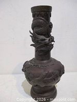 Full view of bronze vase front showing dragon wrapped around neck and bird relief on body