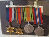 Front view of mounted bar showing all four medals and ribbons