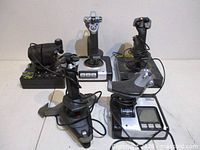 Group shot of five flight simulator controllers showing overall condition and included cords