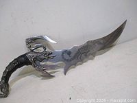 Full view of fantasy sword showing blade profile, scorpion guard and handle