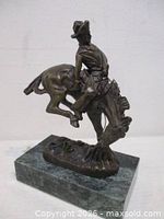 Full view of bronze sculpture on marble base
