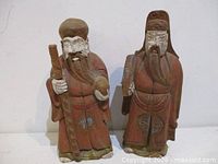 Full view of both carved hardwood deity statues