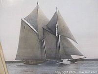 Overall view of hand-coloured photograph showing Bluenose schooner under sail