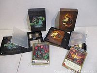Both raid deck boxes opened showing card packs, hero cards, rule insert
