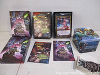 Group shot of all three boxed sets, rule book, oversize and regular cards