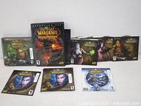 Full lot showing Cataclysm case, five character art sleeves, two night-elf sleeves and Lich King disc