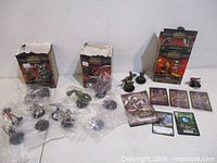 Lot overview showing figures, sealed card packs, loose cards and three opened boxes